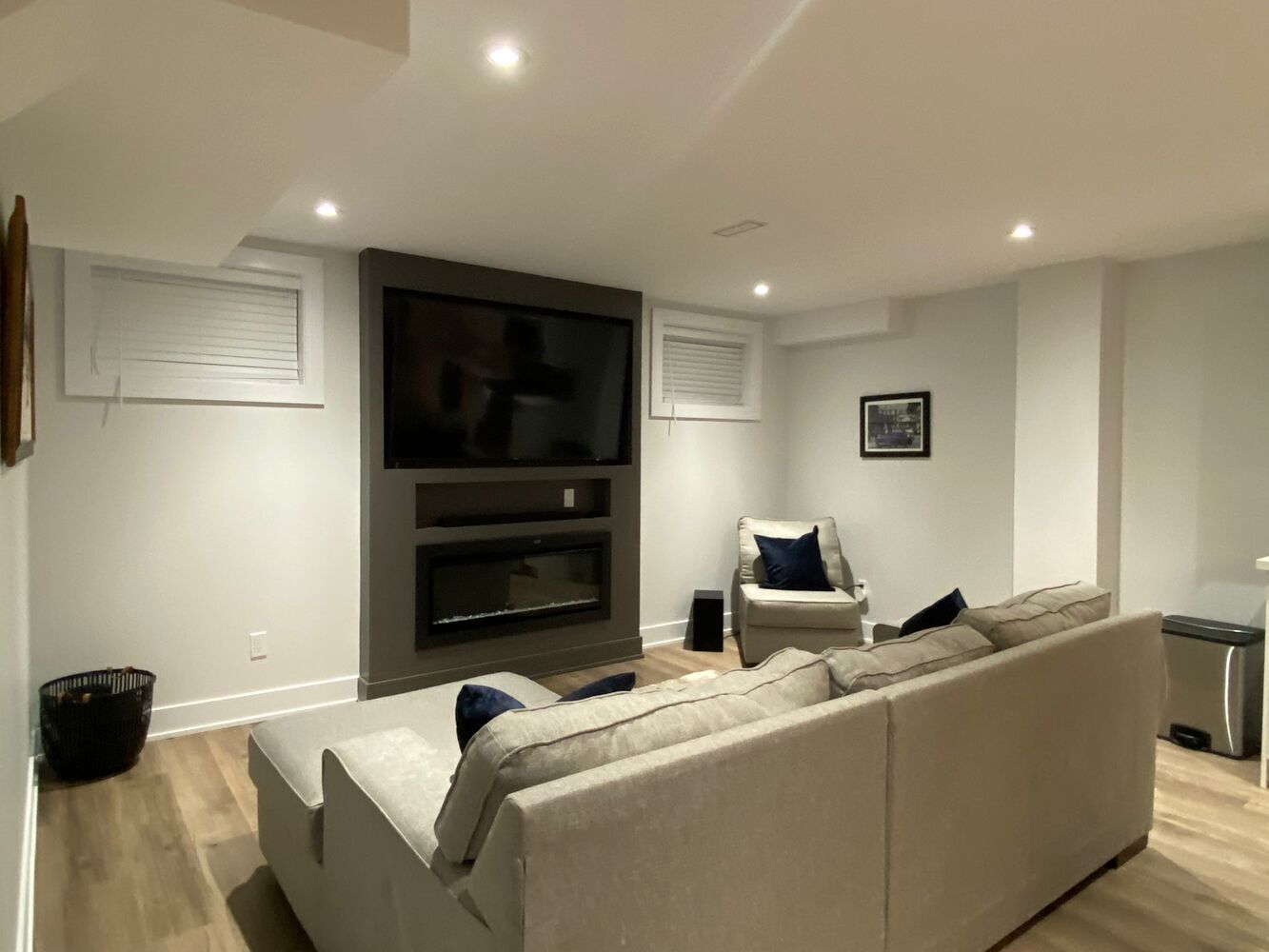 Basement living area with cozy furniture and decor