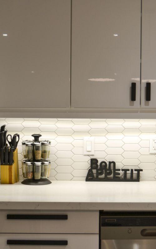 Basement kitchen or bar area with countertop and appliances