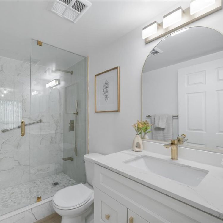 Walk-in shower with glass enclosure and matte black fixtures