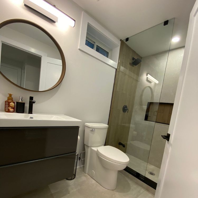 Modern bathroom renovation with double vanity and LED mirror
