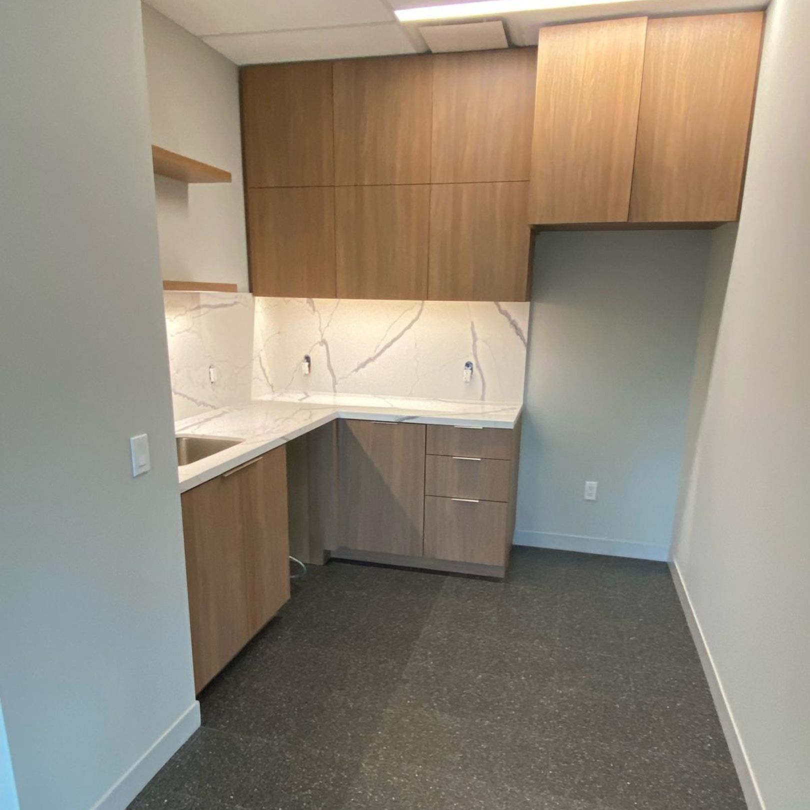 Office breakroom renovation with modern kitchenette and seating area