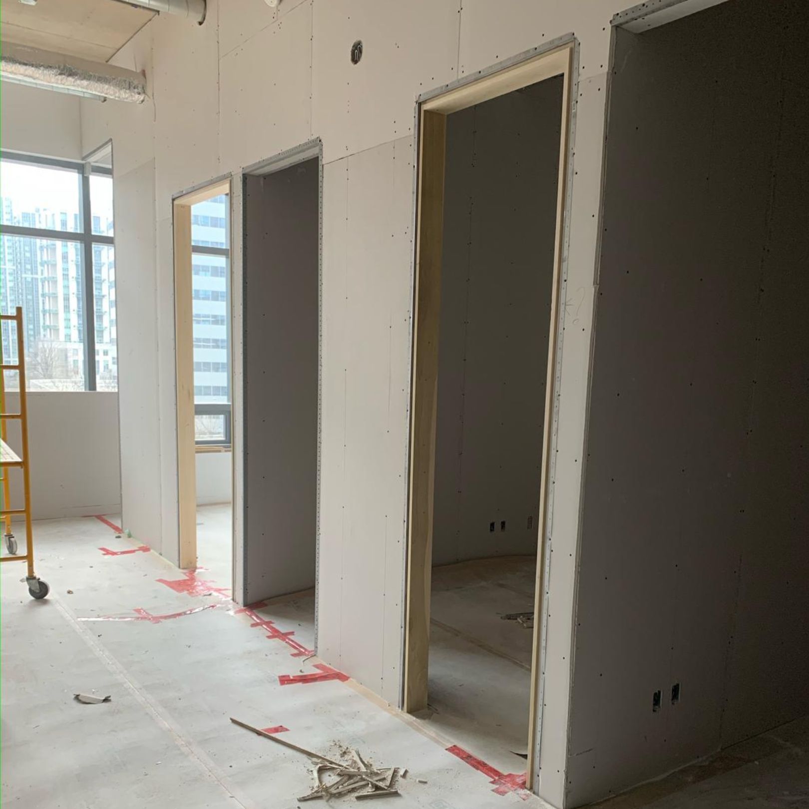 Renovated collaborative workspace with shared tables and acoustic panels